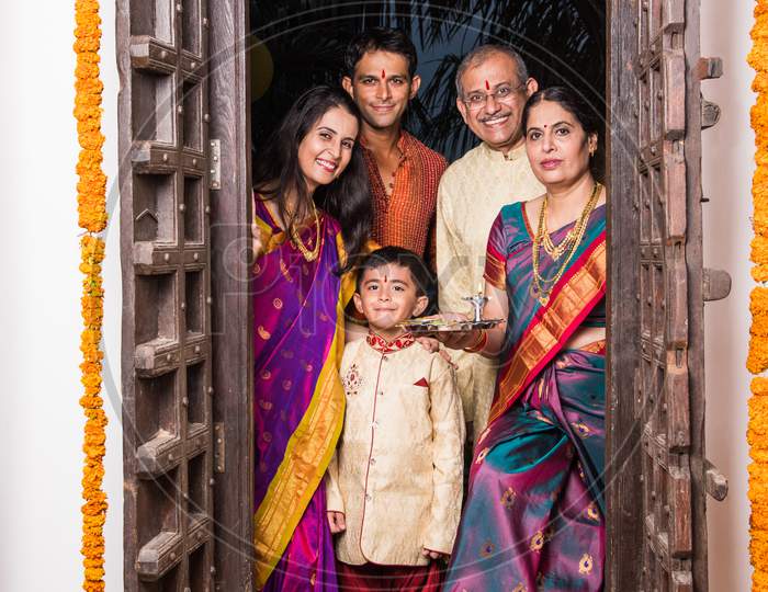 Image of Happy Indian family entering house with puja thali through old ...