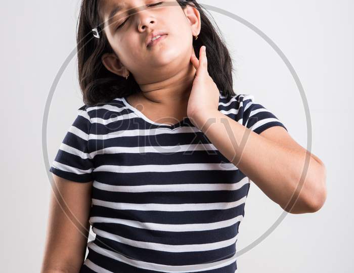 Cute little girl having neck pain or cervical pain