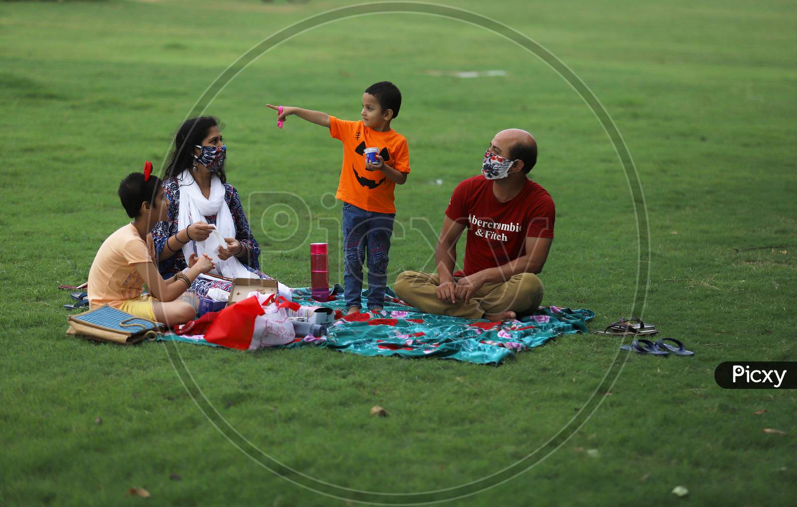 A family of four enjoys an outdoor picnic at Rajpath in New Delhi on July 08, 2020