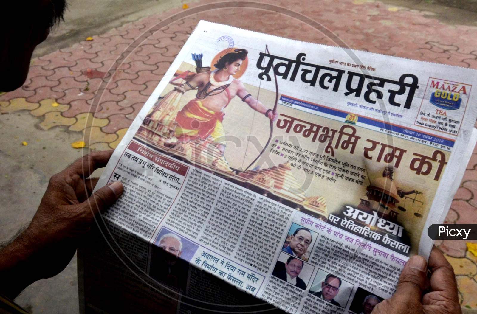 A senior Citizen  read newspapers fronted with headlines on Ayodhya case verdict