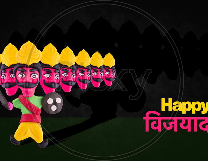 happy Dussehra / Ayudh Puja greeting card with Ravan made using colourful clay or dough