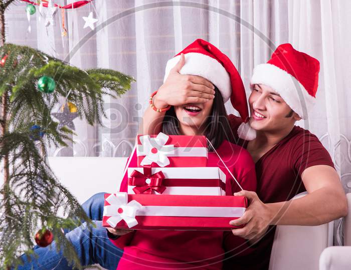 Indians celebrating Christmas or Xmas with family indoors