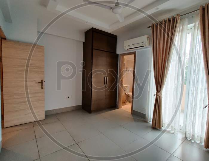 Wide Angle Shot Of Bedroom With Airconditioner And Colorful Curtains