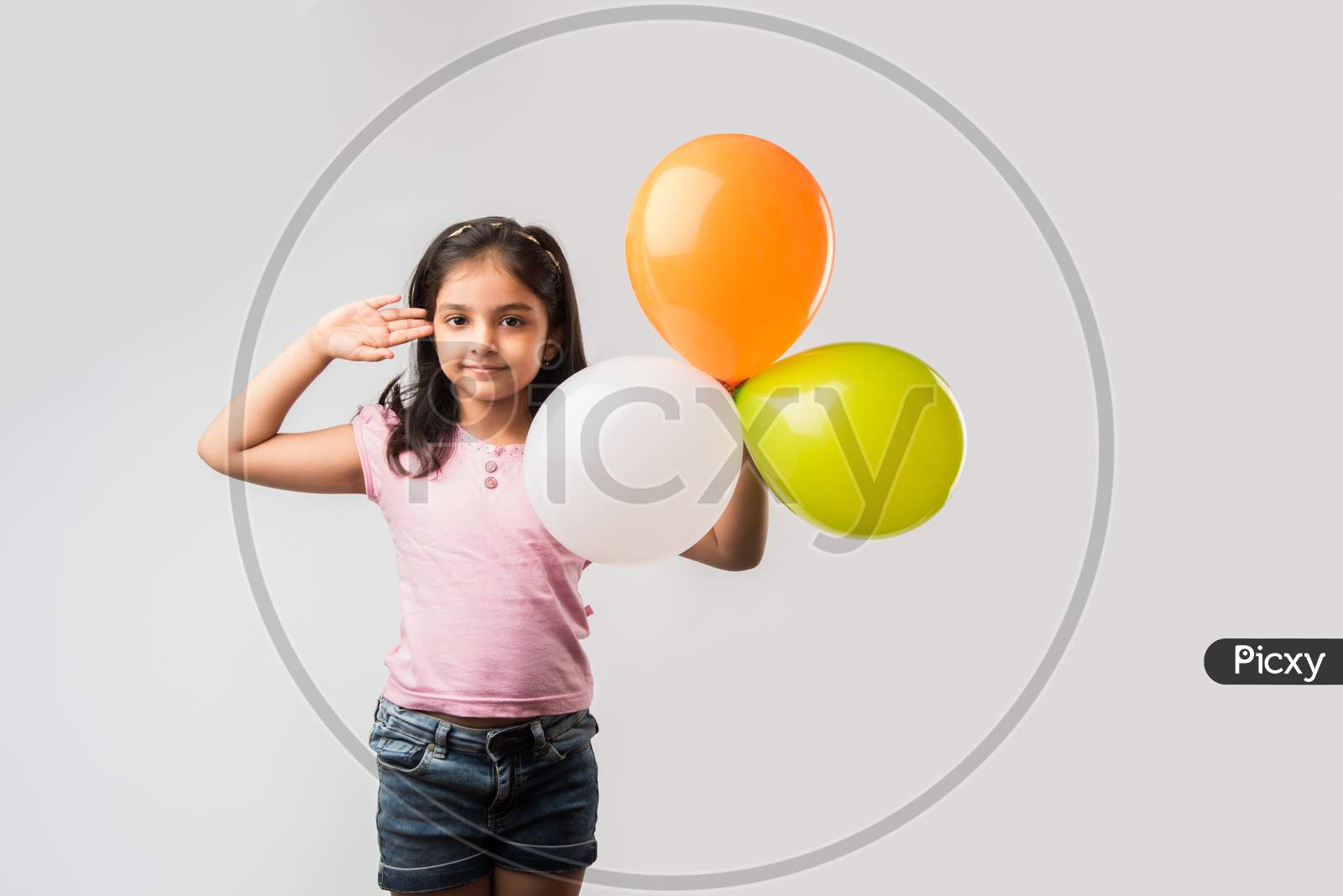 cute little indian girl with tri colour balloons - Saluting national Flag and celebrating Independence or Republic day of India