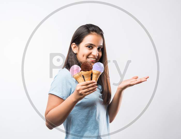 Beautiful young girl eating Ice cream in cone