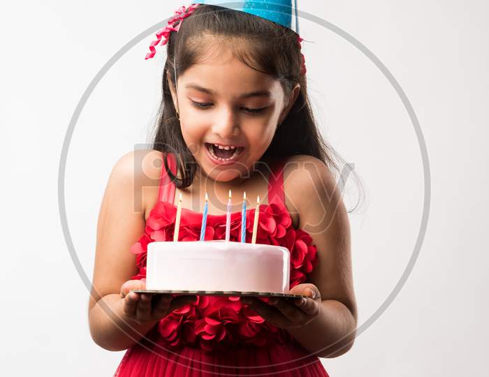 Llittle girl with cake celebrating birthday
