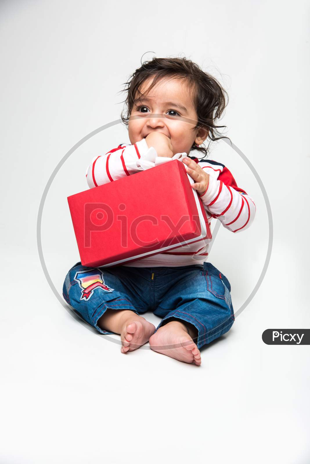 Indian cute little baby /infant or toddler smiling with gift box over white background