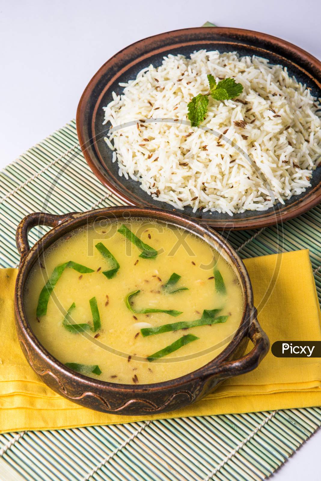 Whole Yellow Lentil dal tadka or fry with Jeera Rice, selective focus