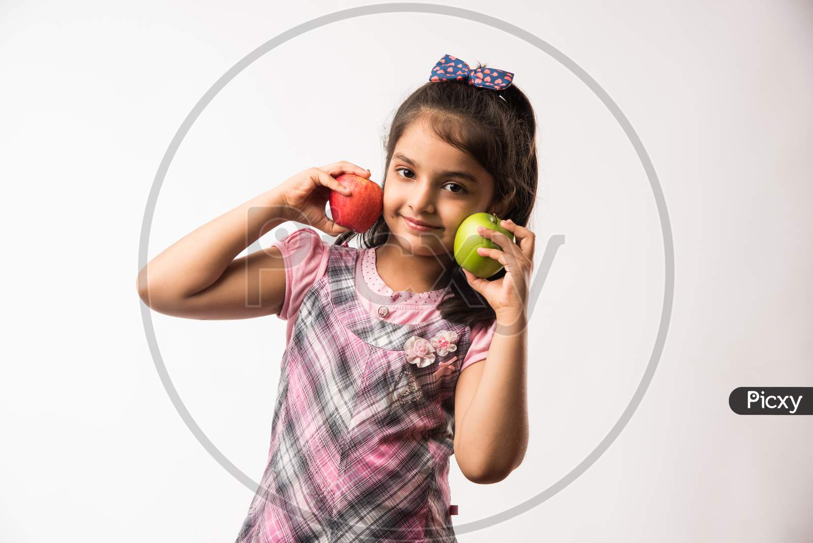 Cute little girl eating apple