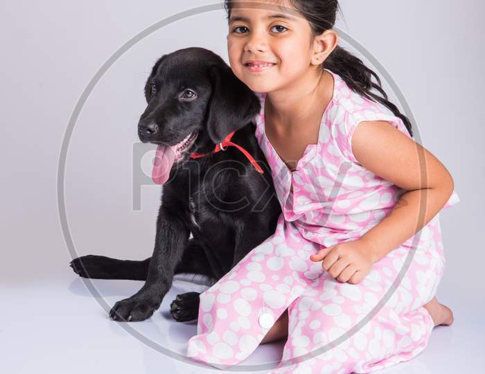 Cute little indian girl with pet dog/puppy