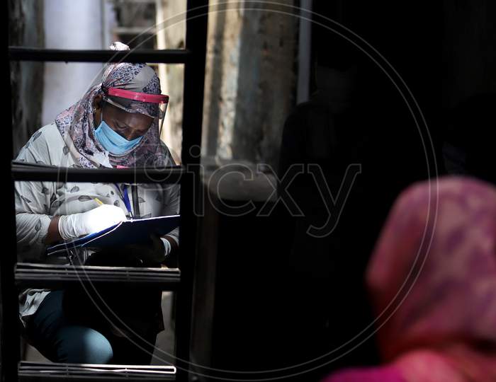 Health workers conduct a community survey in a containment zone in Nabi Karim, New Delhi on July 06, 2020
