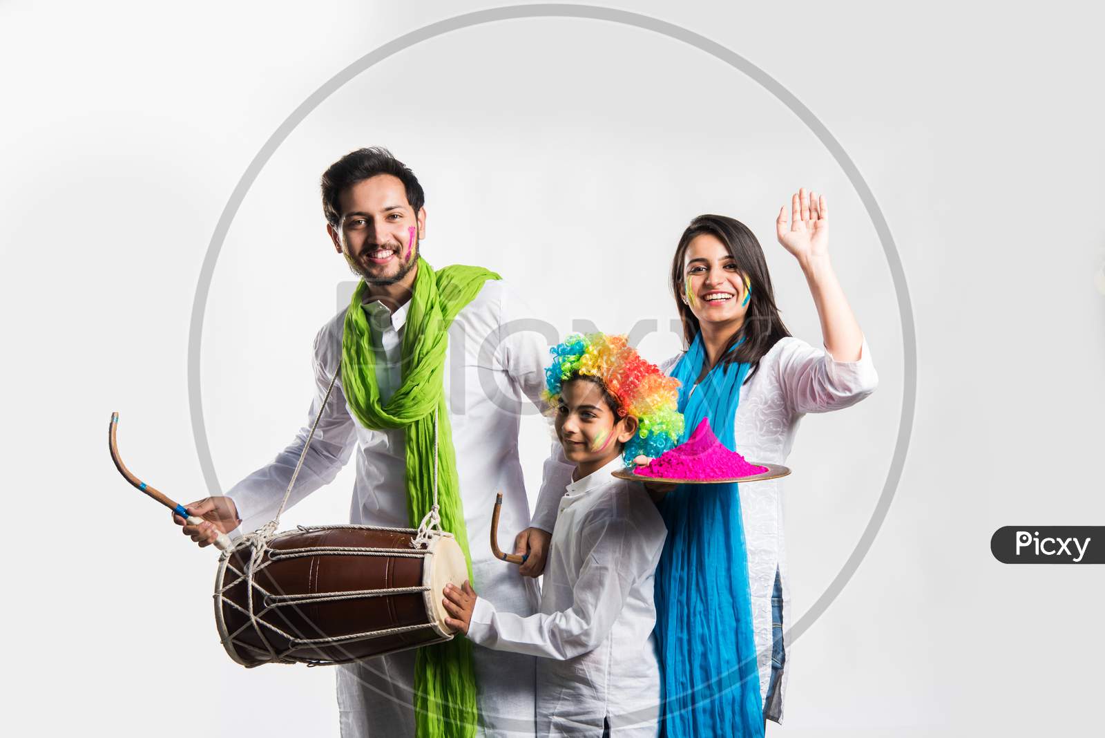 young couple with kid celebrating holi festival