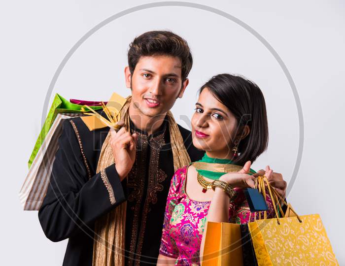 Indian young couple holding shopping bags