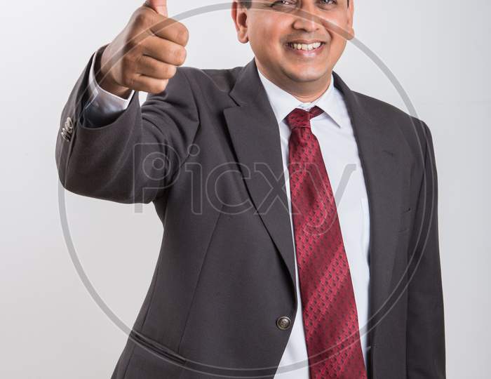 portrait of Indian handsome Businessman showing success / victory / thumbs up