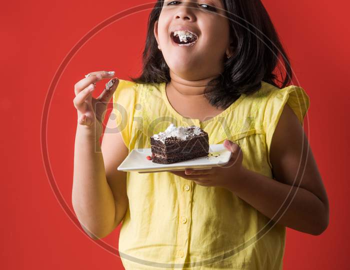 little girl eating cake