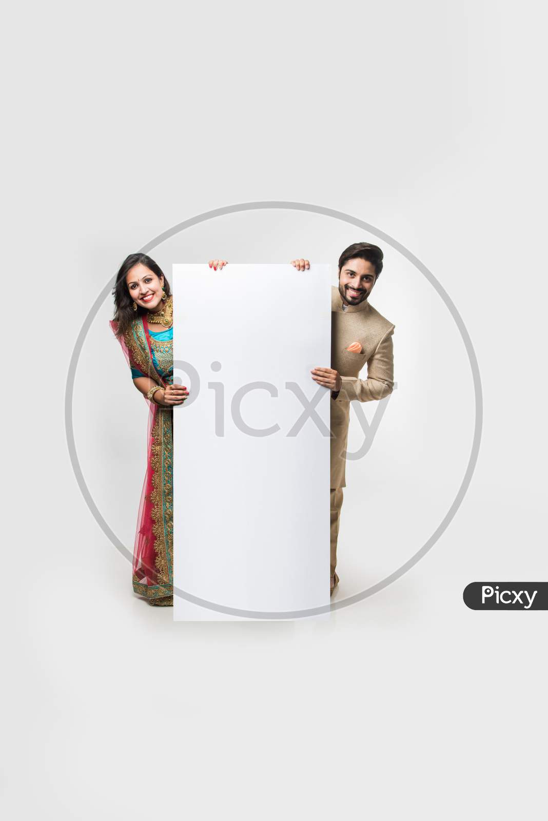 Indian couple holding white board or placard
