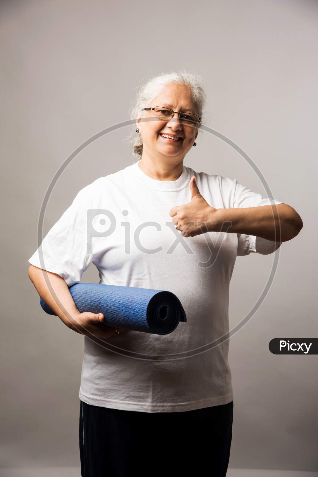 Senior Indian/asian lady exercising - Women Fitness and age concept