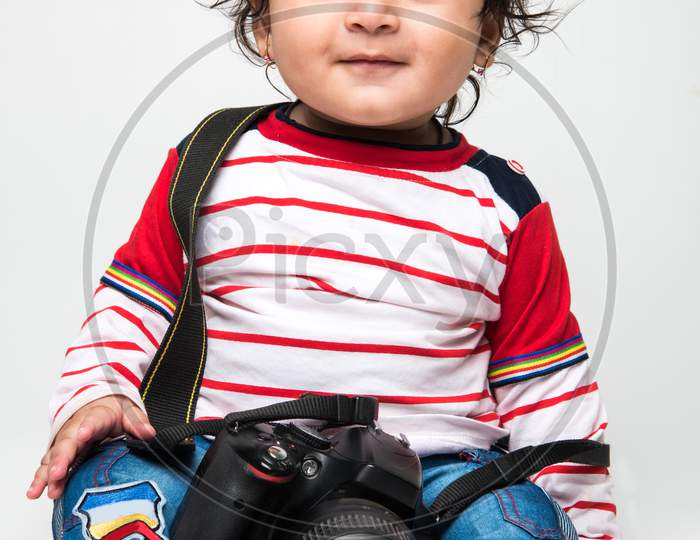 cute little Indian baby boy photographer holding DSLR camera