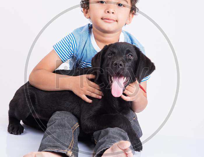 Cute little indian boy with pet dog/puppy