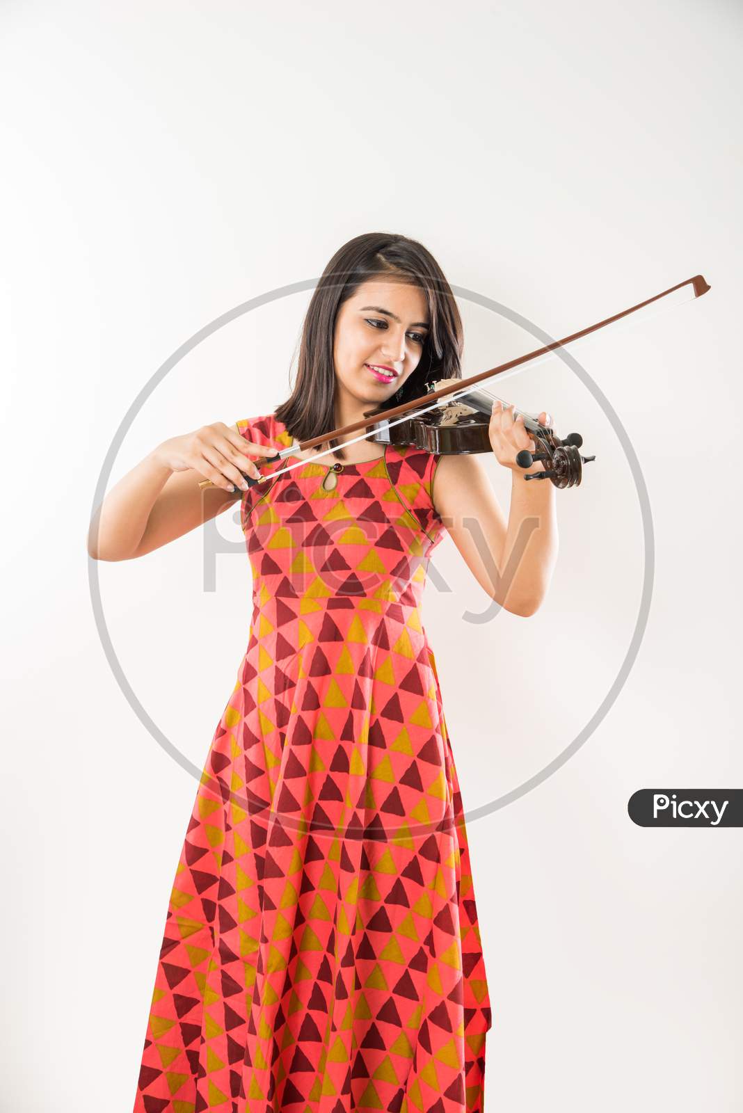 Pretty Indian/Asian young Girl musician playing Violin against white background