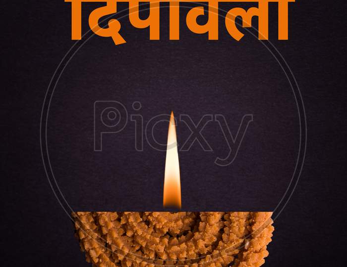 Happy Diwali Greeting card using Half Chakli as a diya with flame added to it