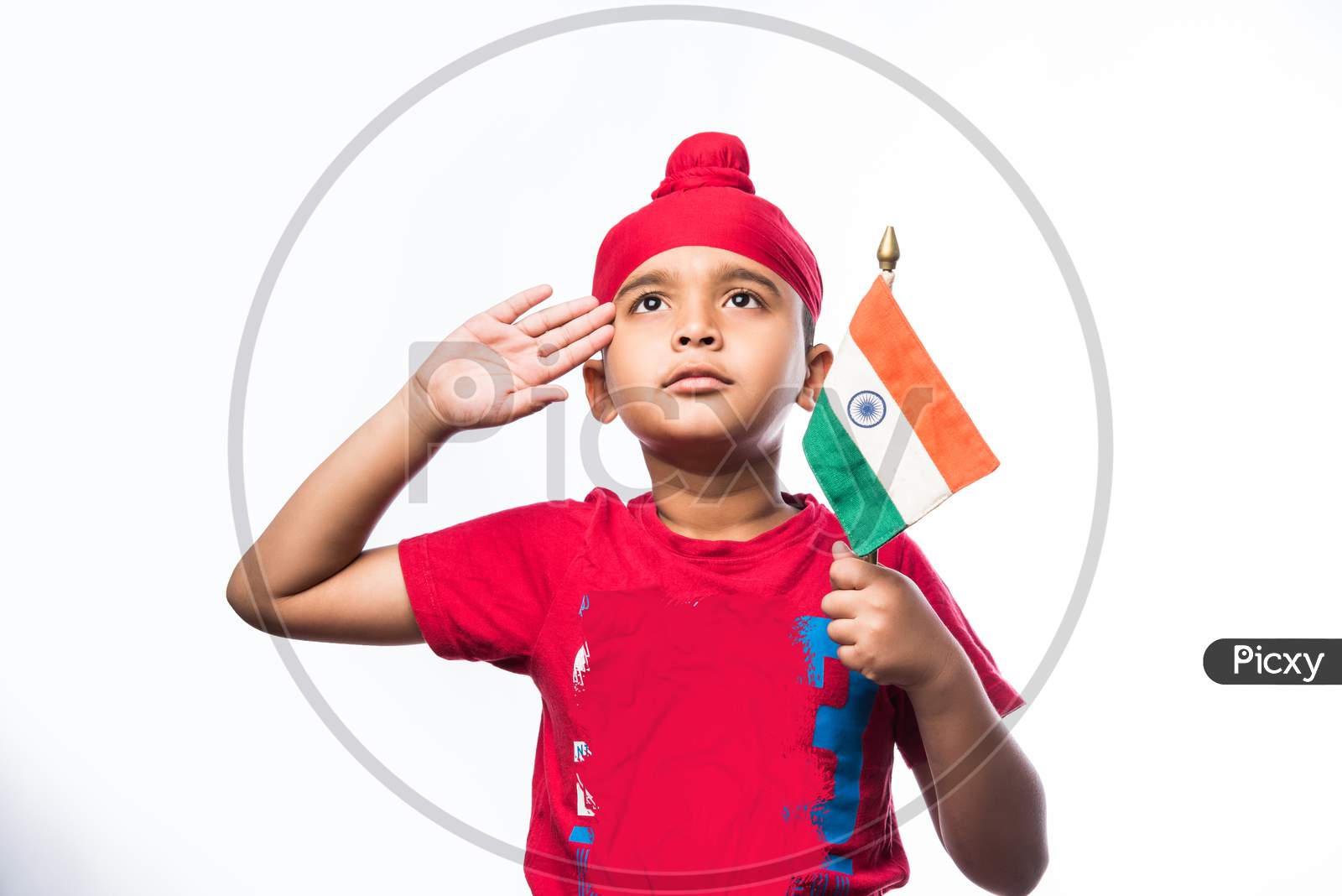 Indian sikh/punjabi little boy holding National Tricolour flag while standing isolated over white background