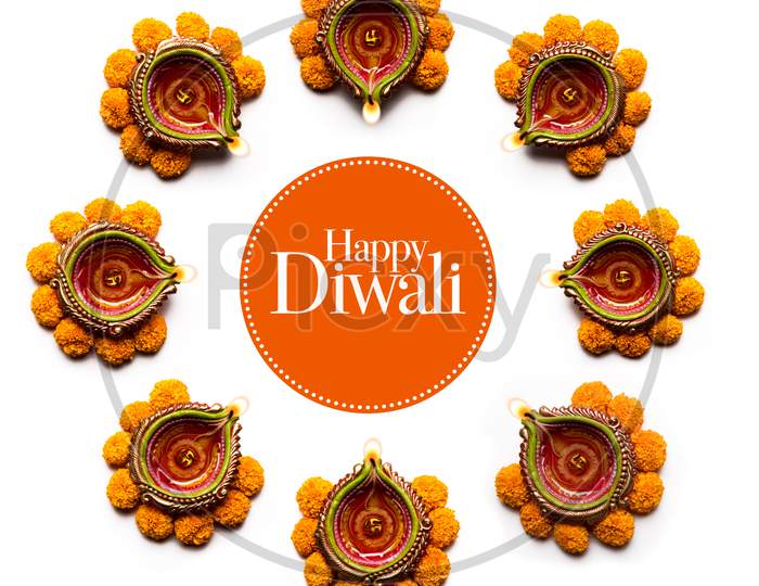 happy Diwali Rangoli made using Diya and flowers