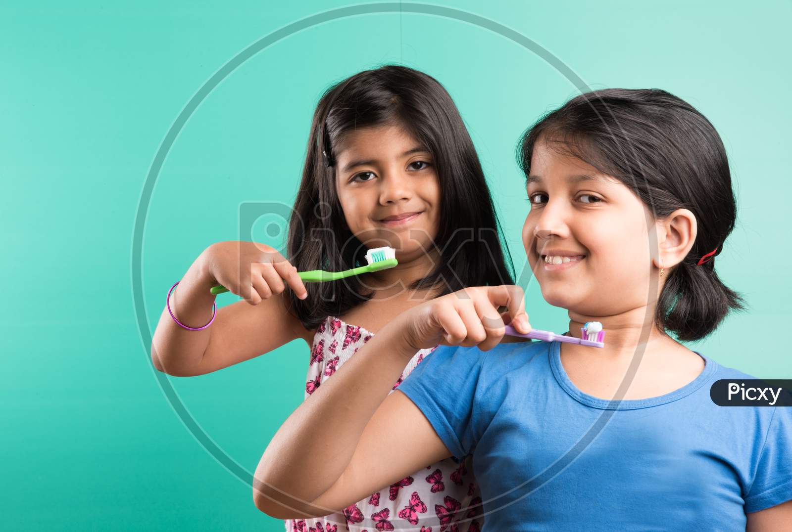 Small girls brushing teeth together