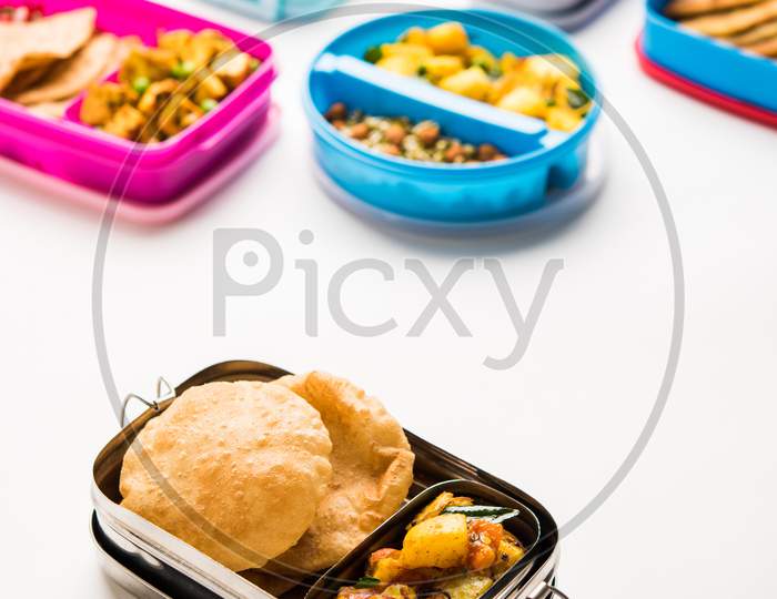 Lunch Box / Tiffin for Indian kids, includes hot poori/puri with potato / aloo sabzi, selective focus