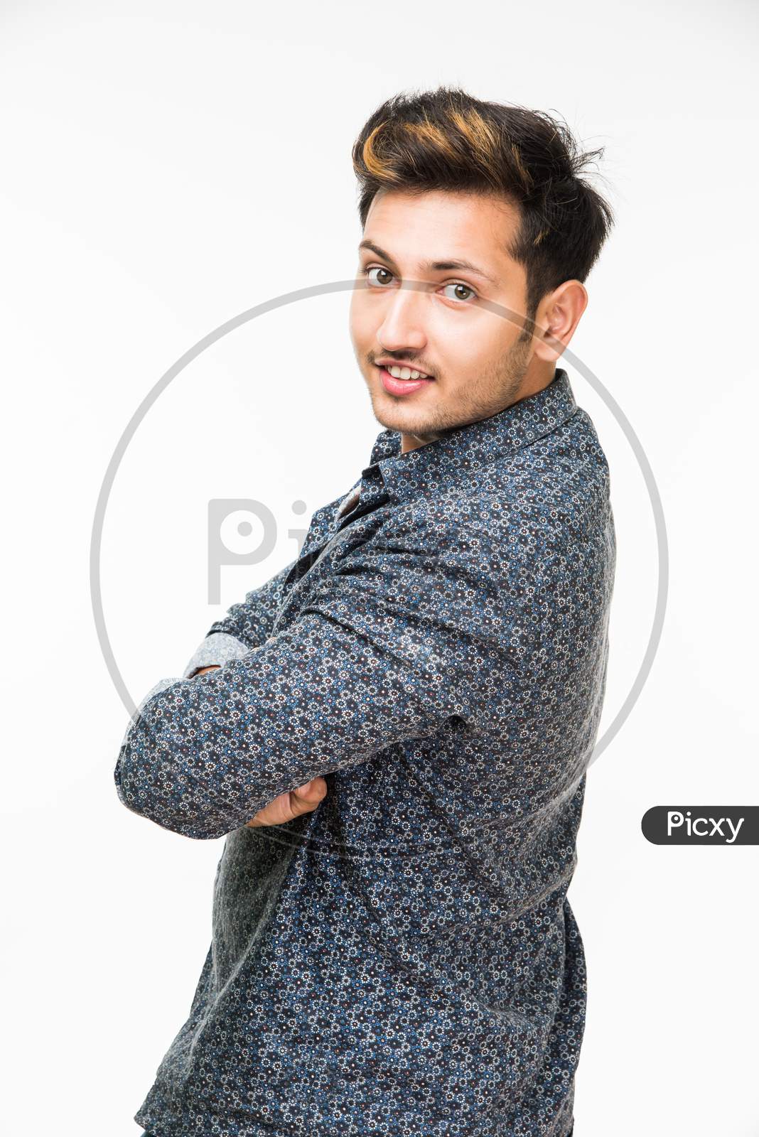 portrait of cheerful Indian young man/boy, standing isolated over white background