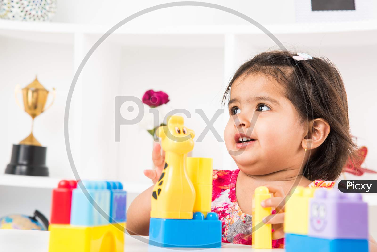 Little girl playing with colourful toys