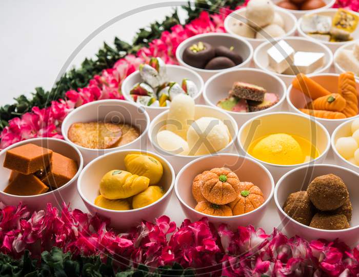 Flower Rangoli with sweets/mithai and diya