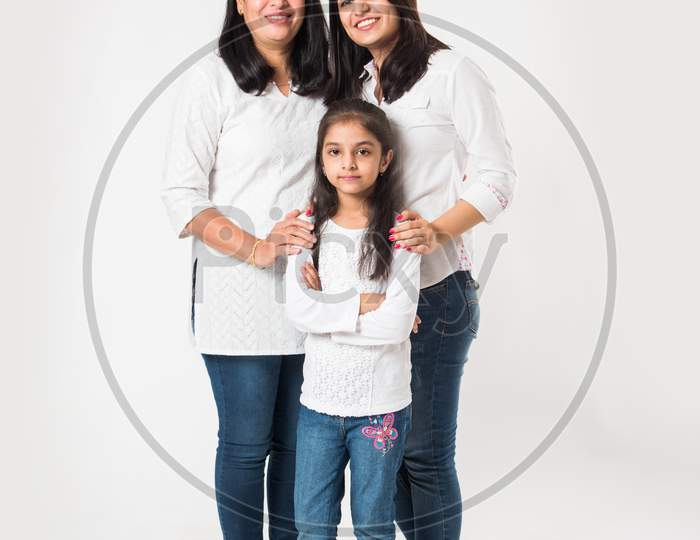three generations of females standing isolated over white background