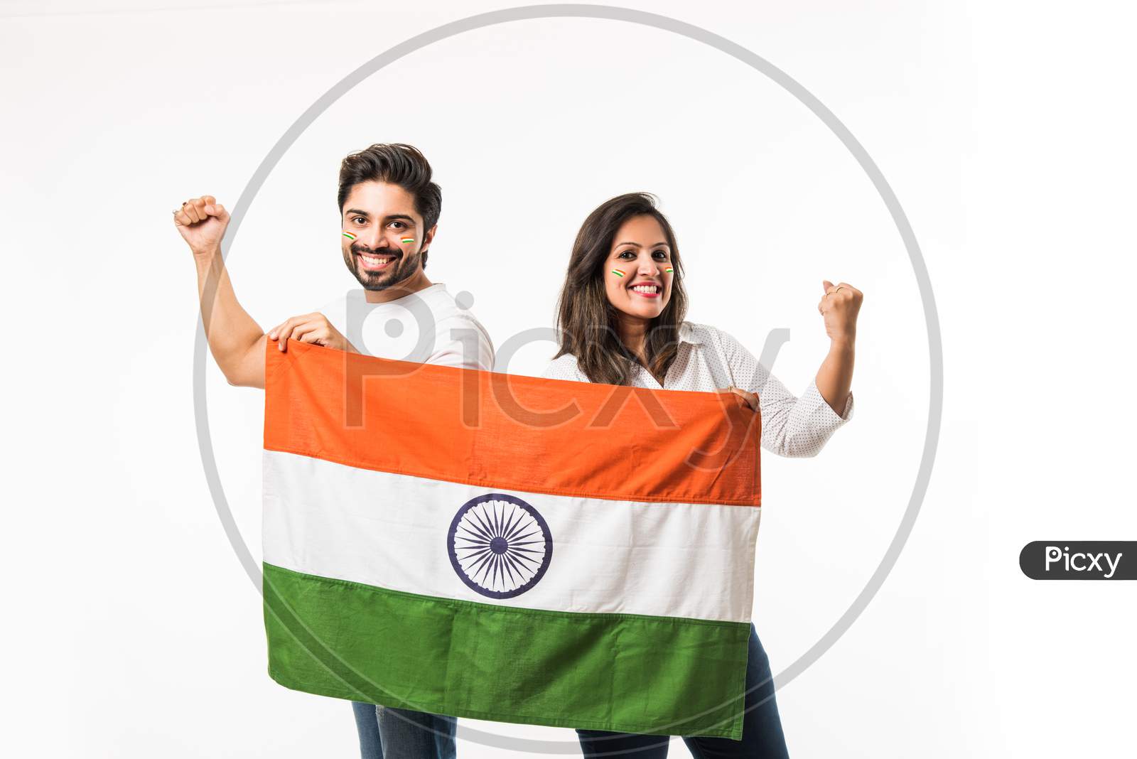 Young Couple holding Indian Flag on Independence or republic day, standing isolated over white background. selective focus