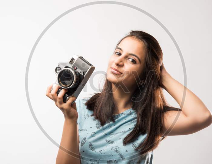 Young beautiful indian girl holding antique Photography camera