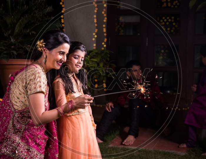 Indian mother and daughter celebrating diwali festival