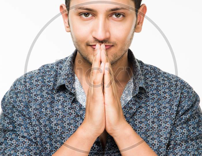 portrait of cheerful Indian young man/boy, standing isolated over white background
