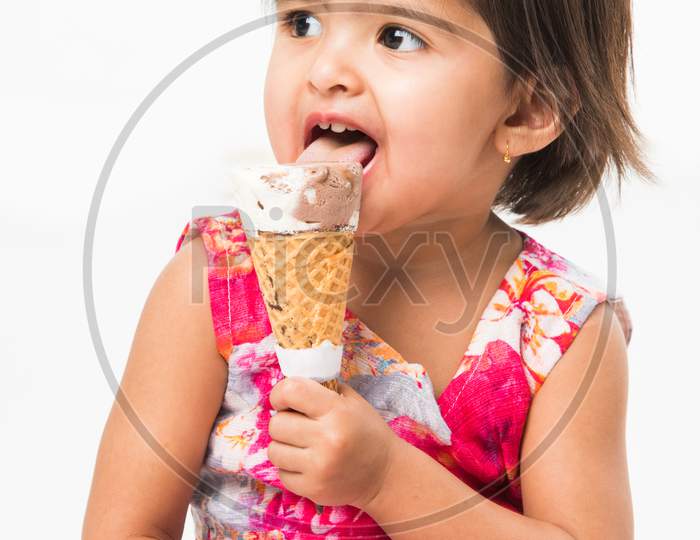 cute little girl eating Ice cream in cone