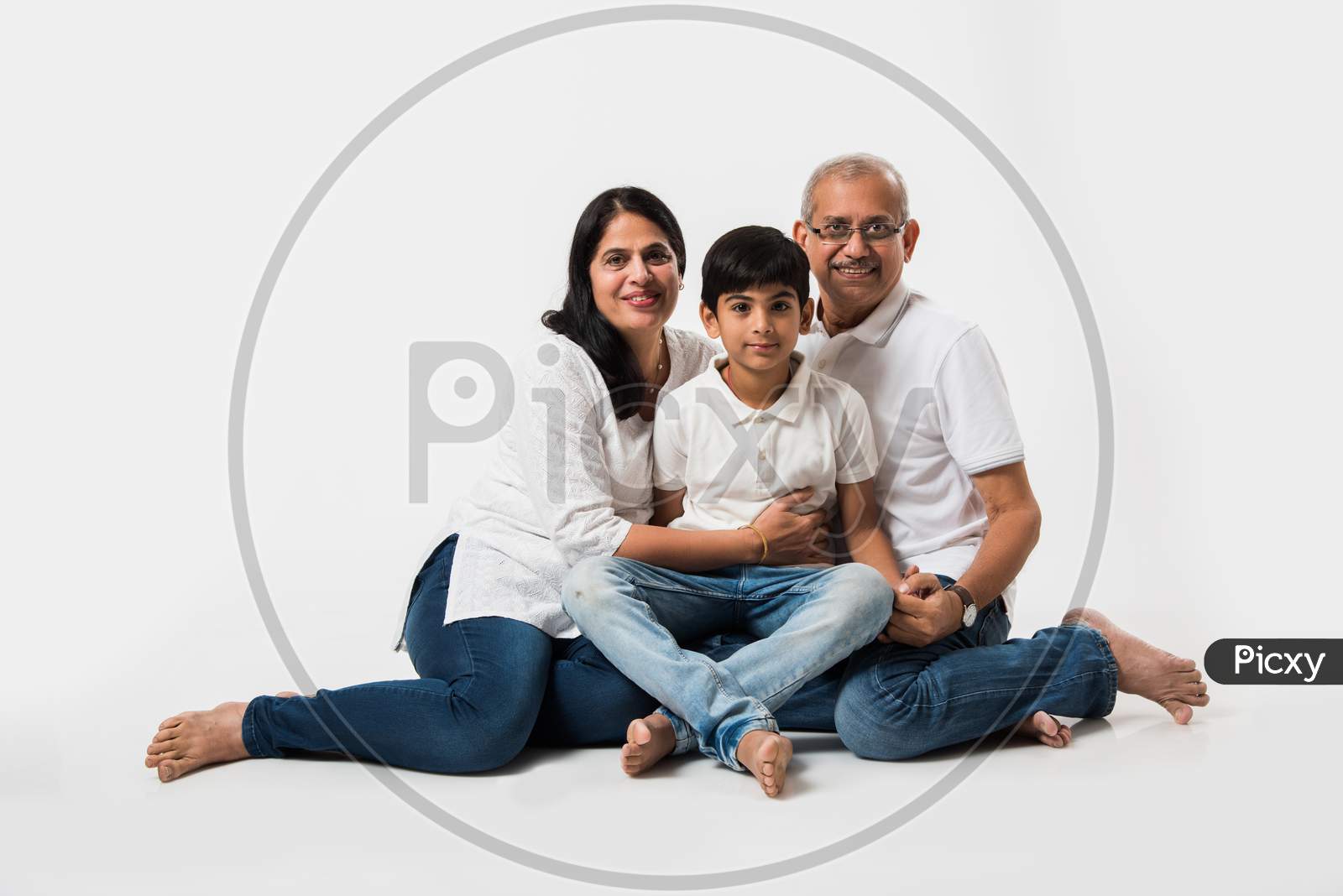 Indian senior couple with grandson, isolated over white