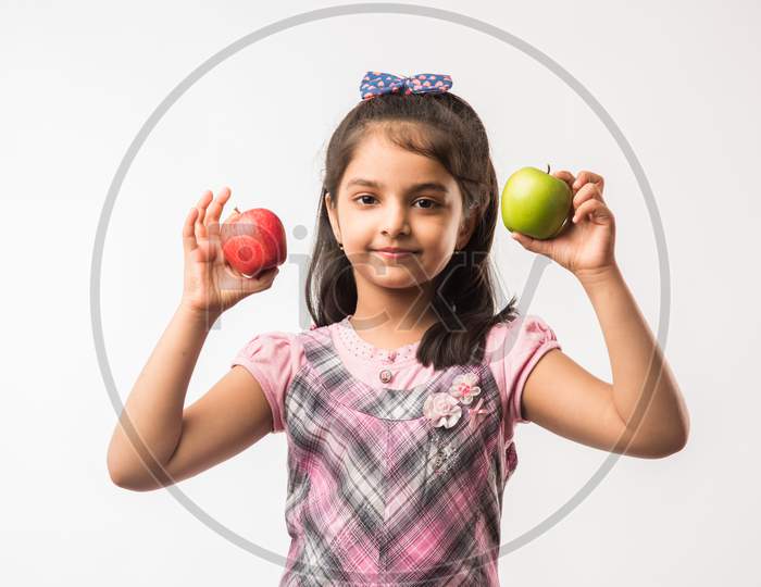 Cute little girl eating apple