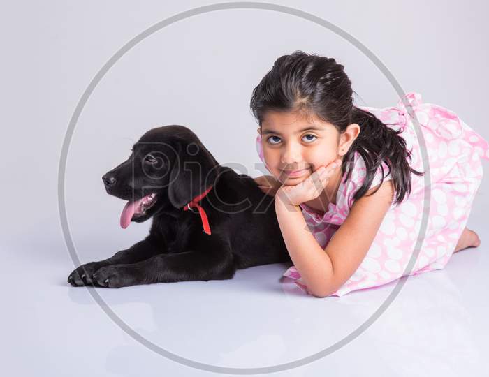 Cute little indian girl with pet dog/puppy