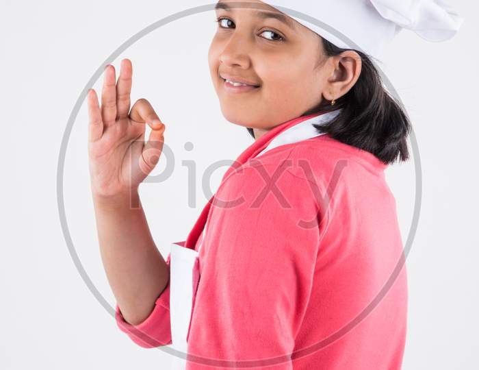 Small girl chef with hat and spatula