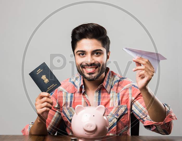 Piggy Bank, Passport and flight - Indian man with money box and paper plane, showing saving and foreign tour concept