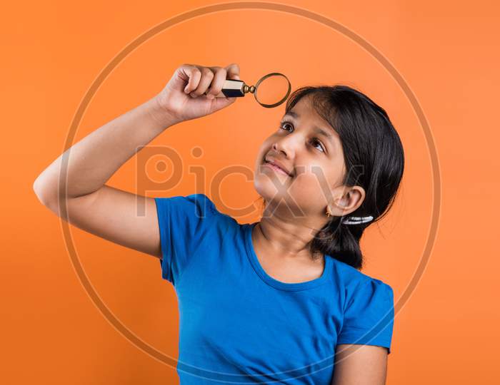 small School girl with magnifying glass