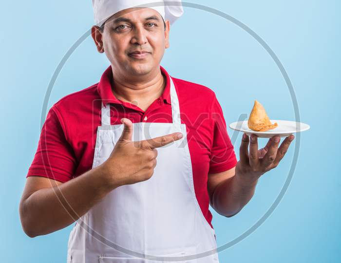 Indian Male Chef / cook in apron and wearing hat