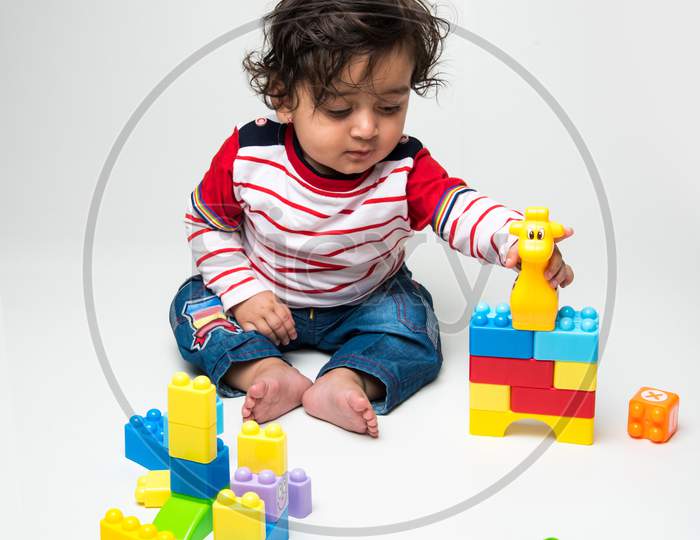 cute little Indian baby boy playing with toys
