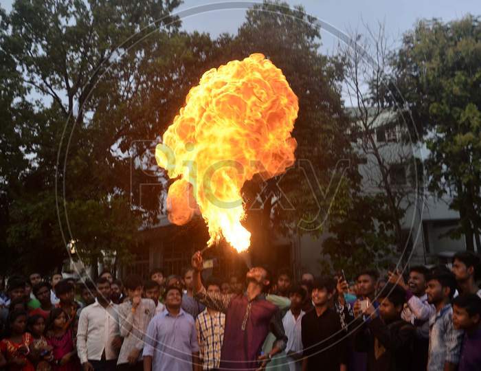 Fire eaters perform stunts on the occasion of Muharram during a procession