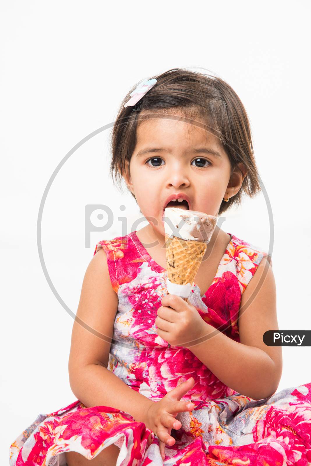 cute little girl eating Ice cream in cone