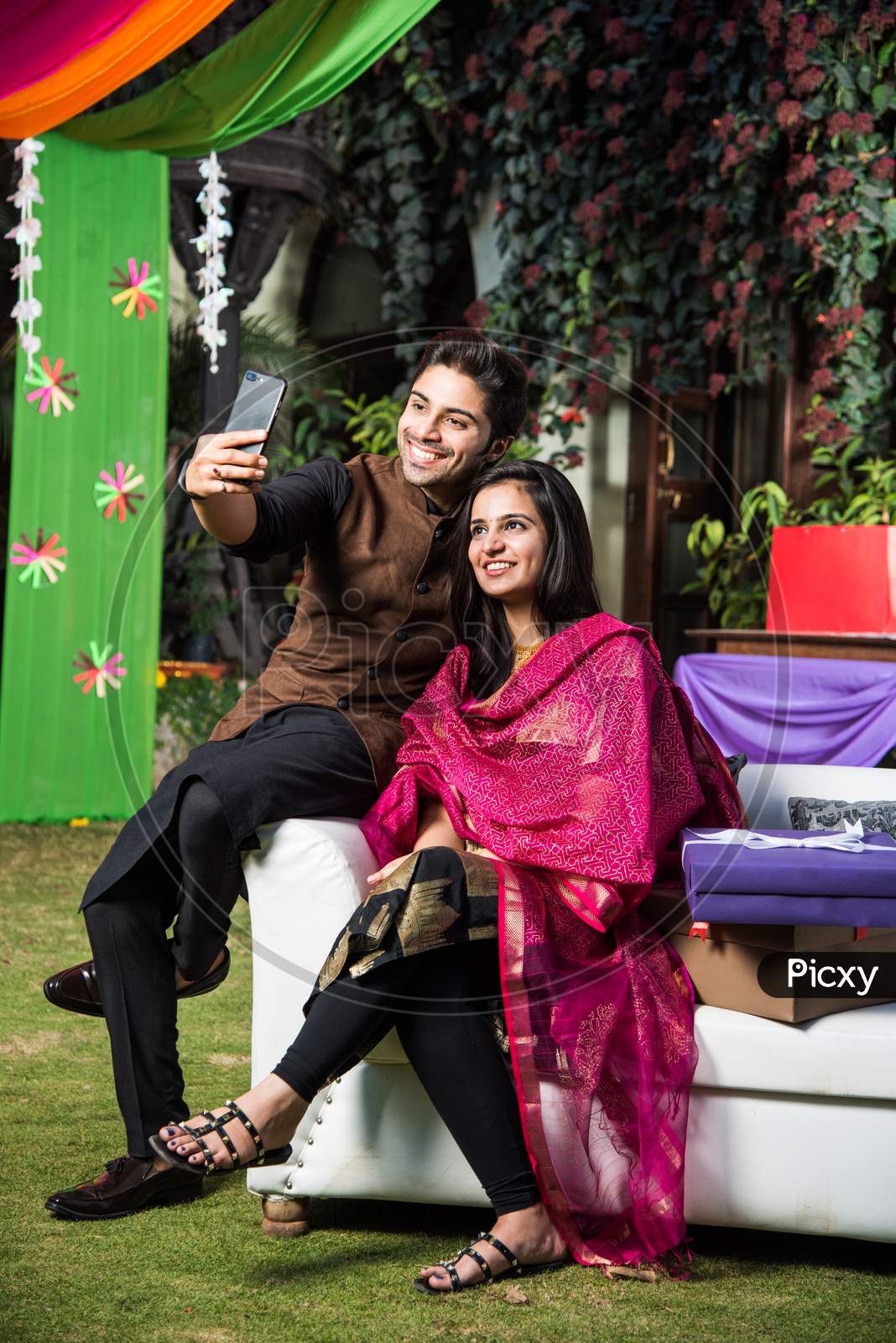 Couple taking selfie with smartphone on diwali or wedding party