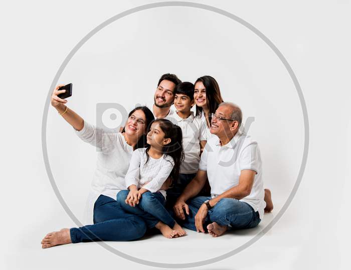 family taking selfie picture white sitting on white background